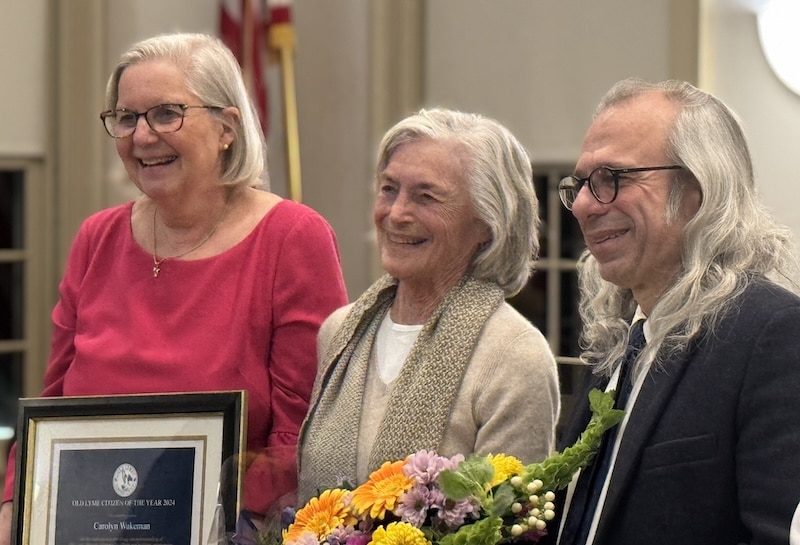 Members of the Board of Selectmen flank honoree Carolyn Wakeman.