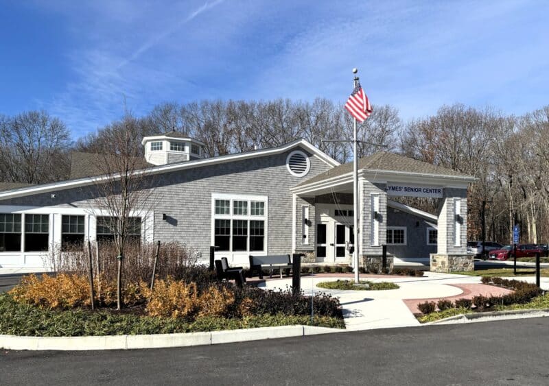 a grey building with a flag pole flying an american flag