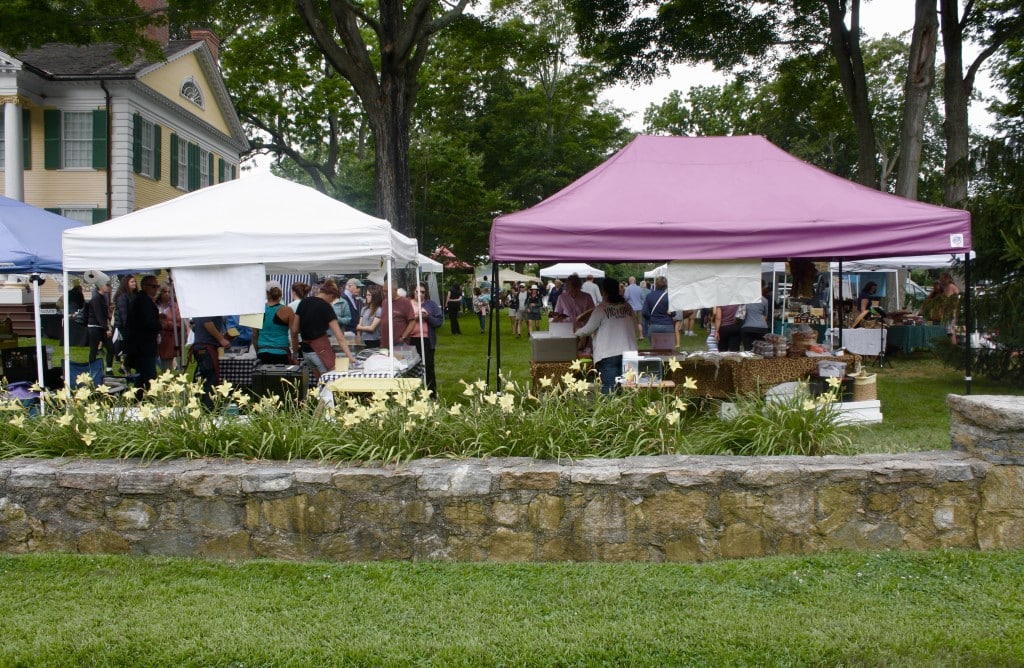 Booths are seen on the grounds in front of the Florence Griswold Museum.