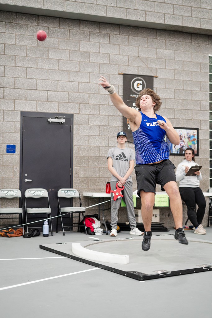 Tyler Cann throws the shot put.