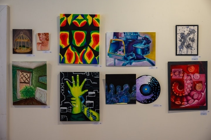 Nine paintings are shown on a wall at the 2025 Future Choices show.