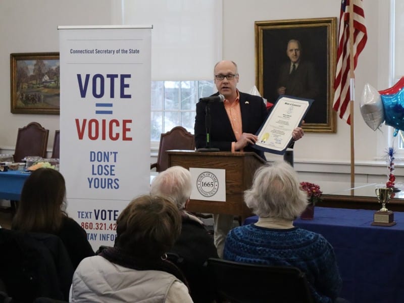 State Rep. Devin Carney, R-Old Lyme, holds up a citation at the podium while speaking at the presenation.