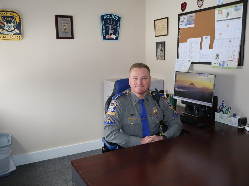 McGregor poses for a photo at his desk.