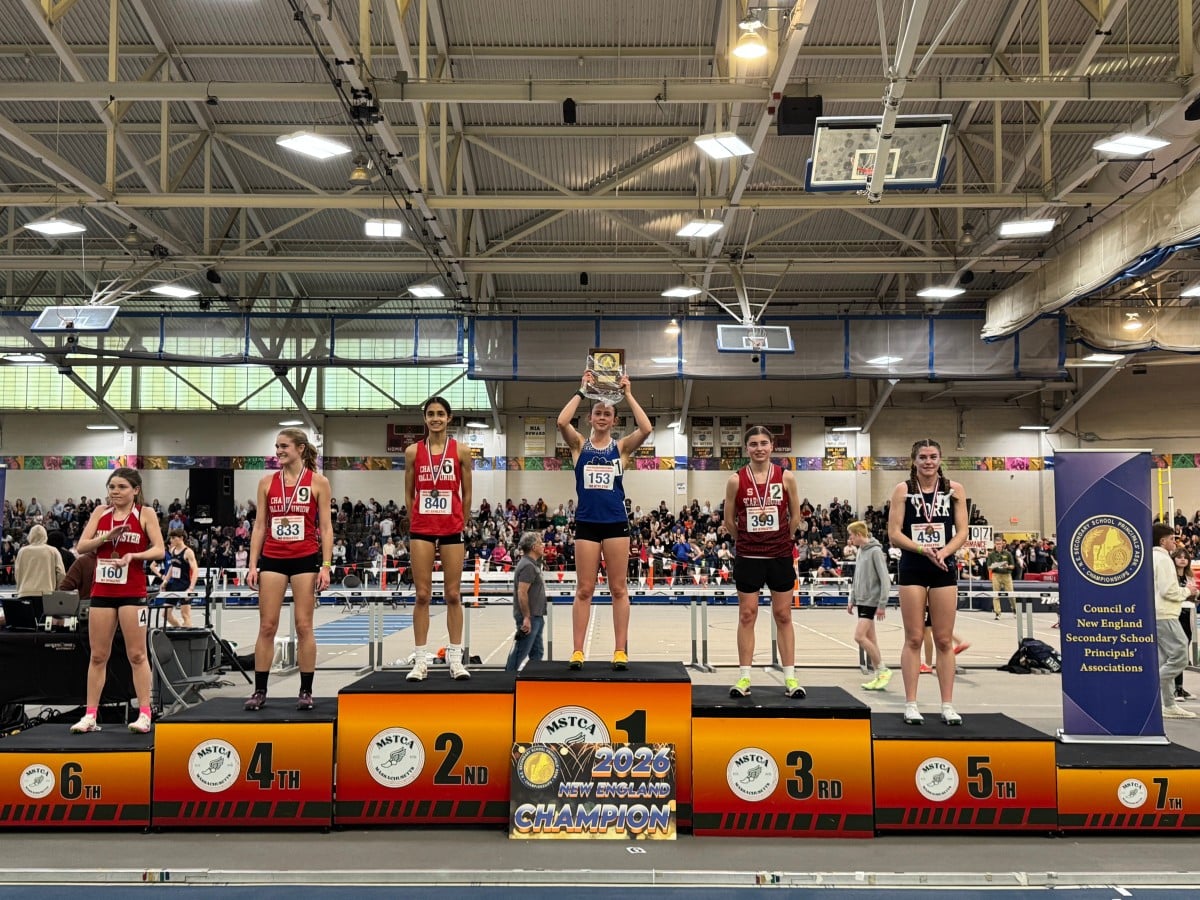 Gilbert holds up her plaque in the number one spot on the 6-person podium.