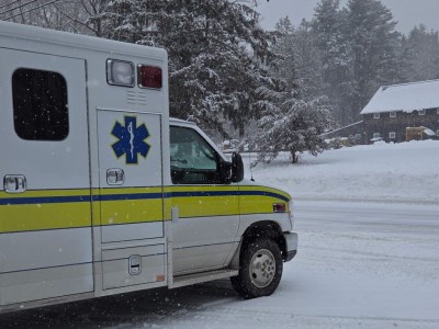 An ambulance is facing the road in front of the Hadlyme fire station.