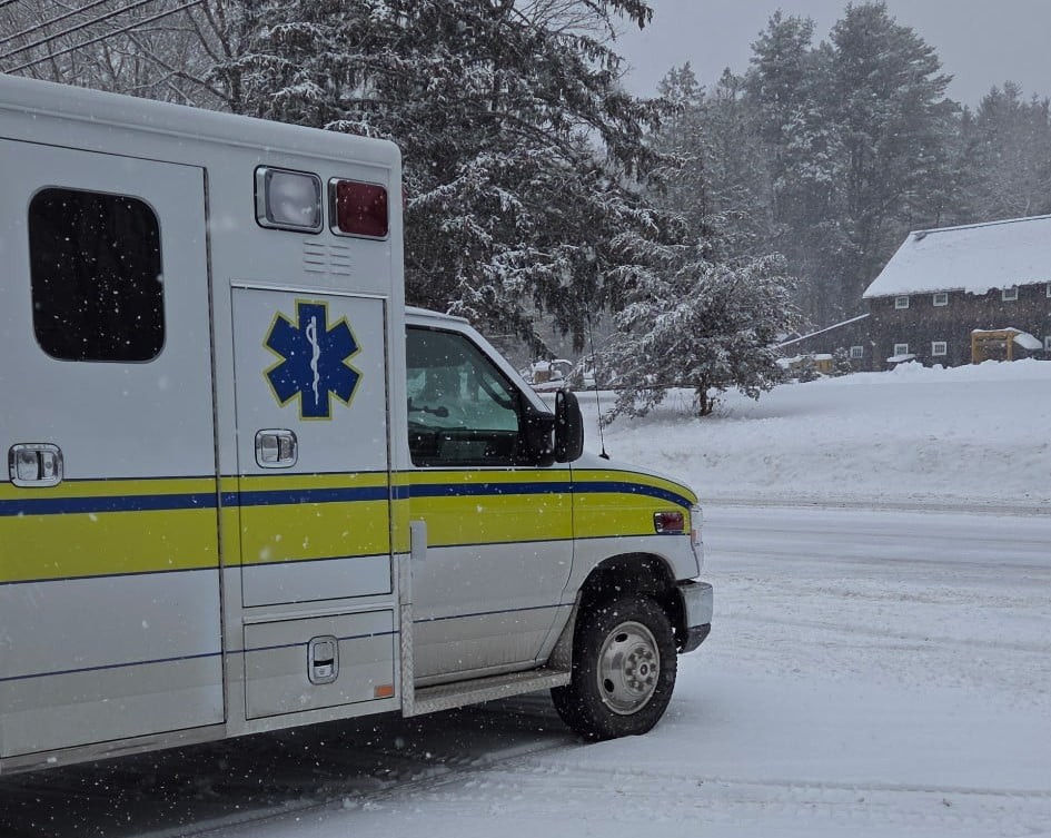 An ambulance is facing the road in front of the Hadlyme fire station.