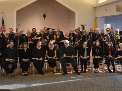 Old Lyme Town Band members pose for a photograph with one row seated and two rows standing behind.