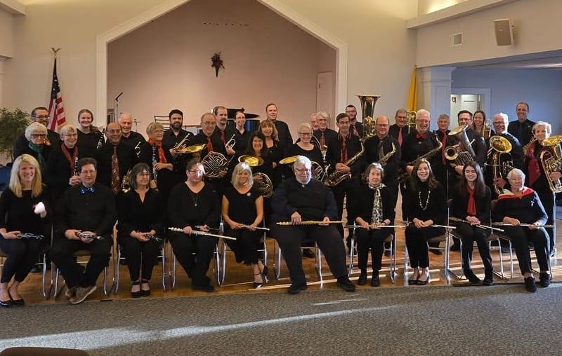 Old Lyme Town Band members pose for a photograph with one row seated and two rows standing behind.