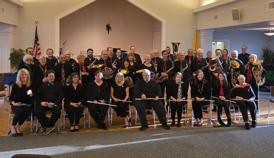 Old Lyme Town Band members pose for a photograph with one row seated and two rows standing behind. 