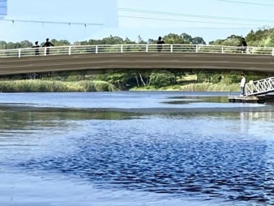 A bridge of engineered wood is shown over the river.
