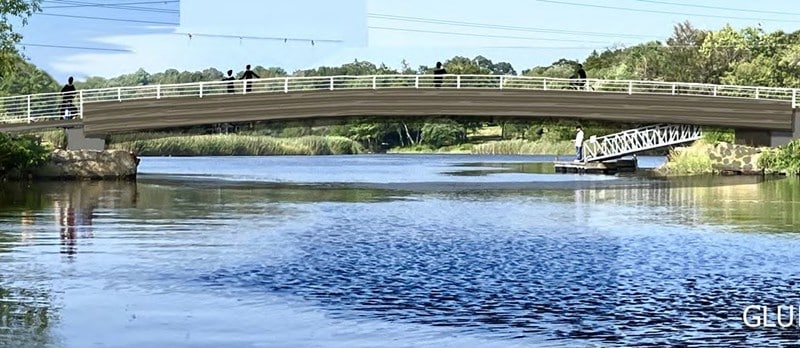 A bridge of engineered wood is shown over the river.