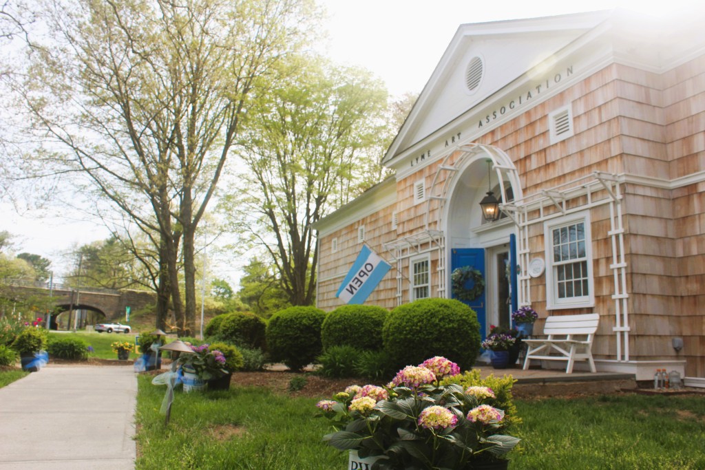 A view of the Lyme Art Association building from the front, with the Lyme Street highway overpass in the distance. 