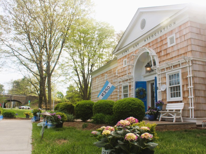 A view of the Lyme Art Association building from the front, with the Lyme Street highway overpass in the distance.