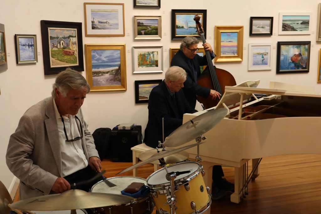 A drummer, pianist and bassist play.