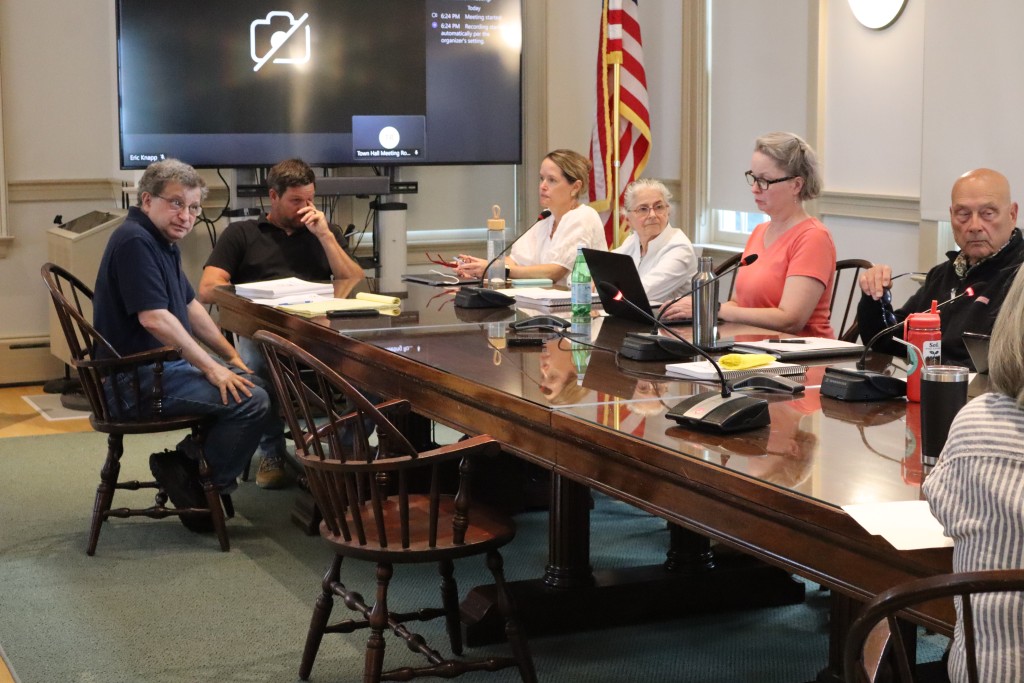 Commissioners sit around a table.